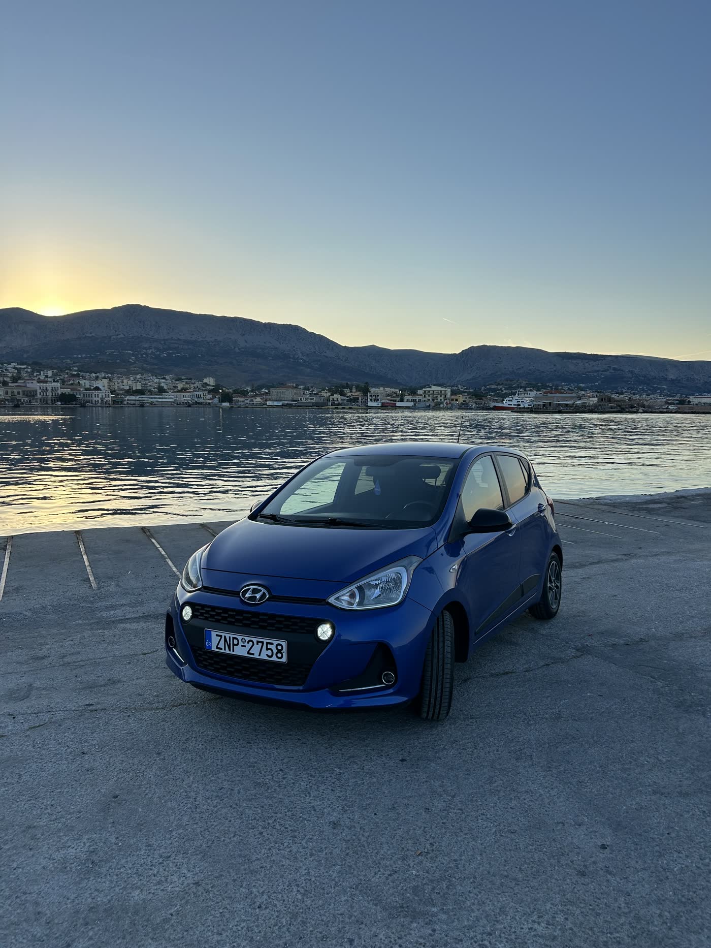 Blue Hyundai i10 at golden hour by Chios harbour