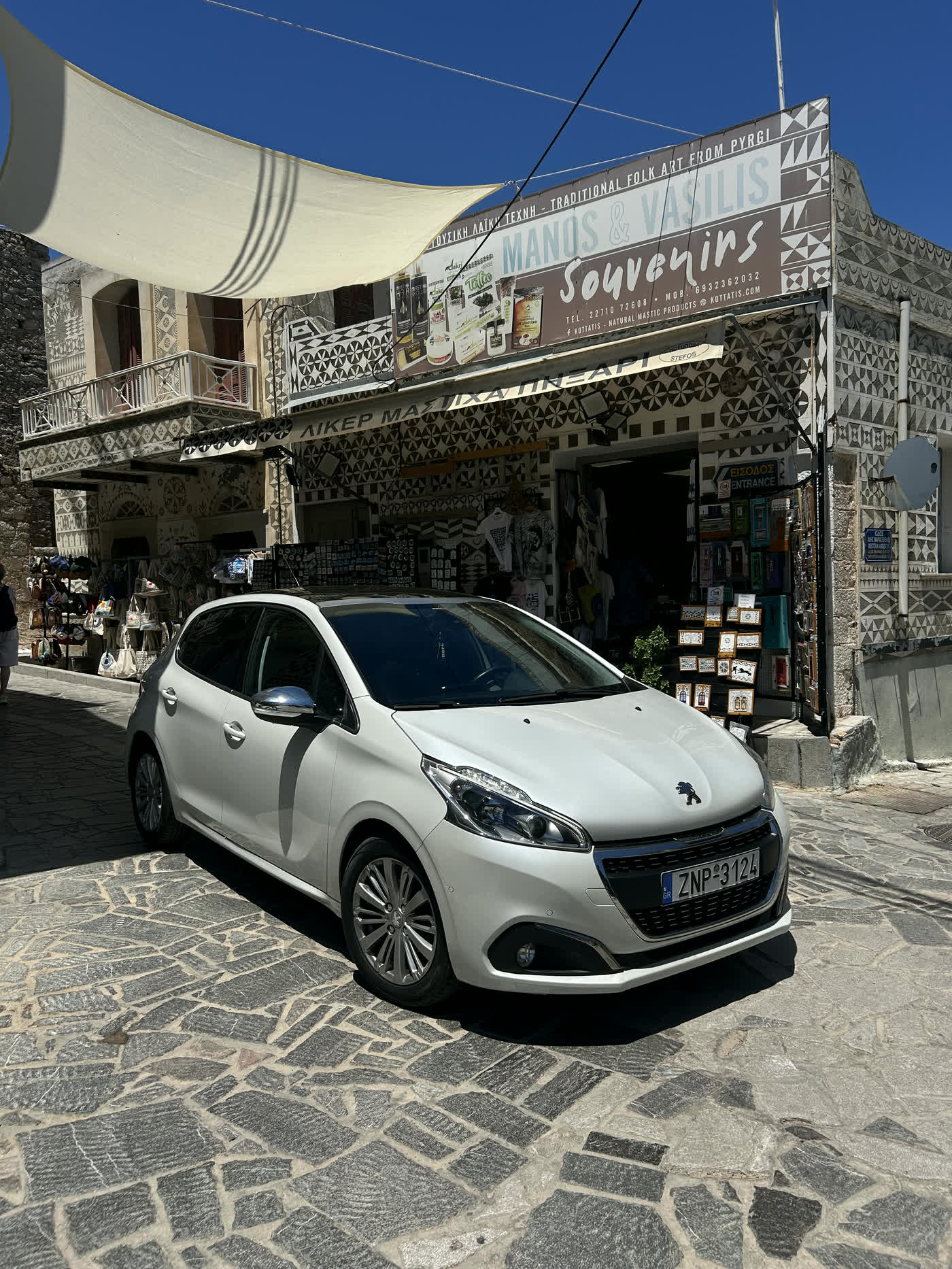 White Peugeot 208 automatic parked in Pyrgi village, Chios